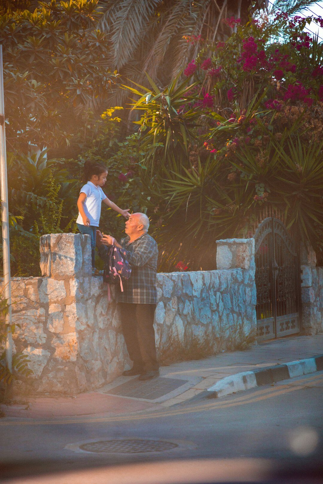 Photographer interviewing an elderly local resident outdoors