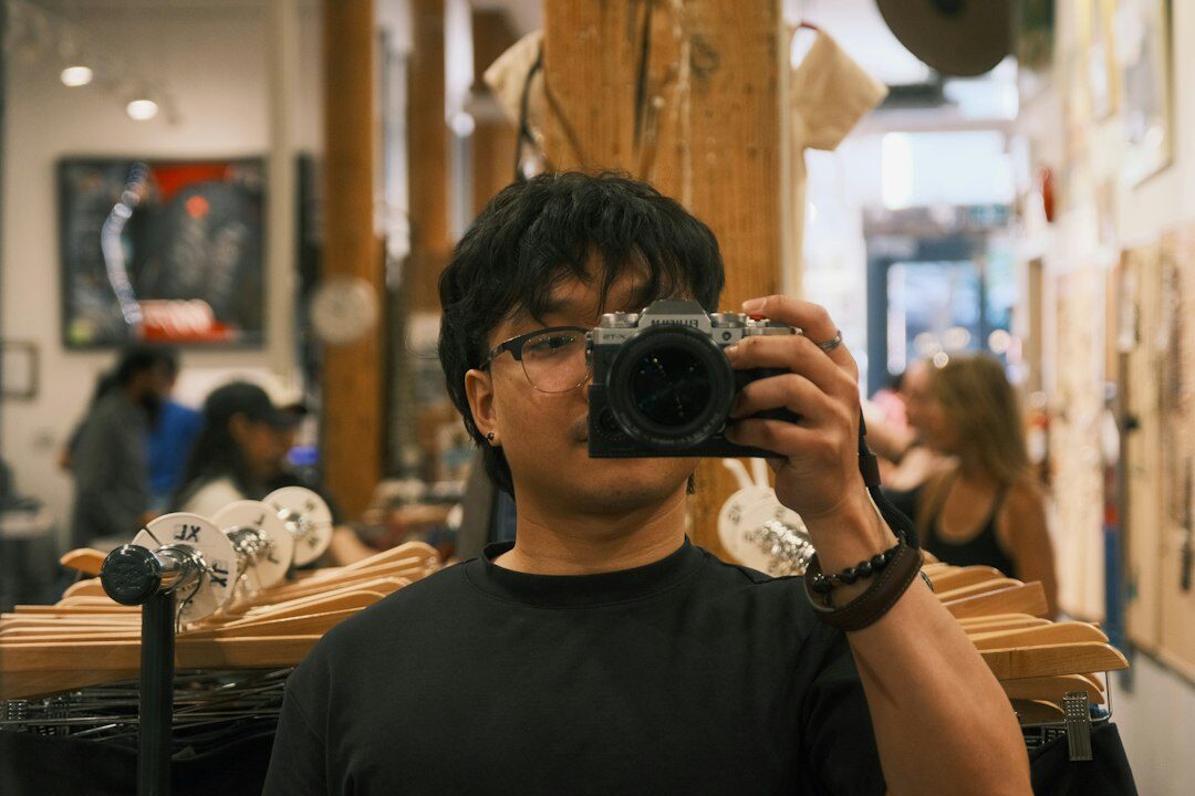 Photographer taking a portrait of a local craftsman in a workshop