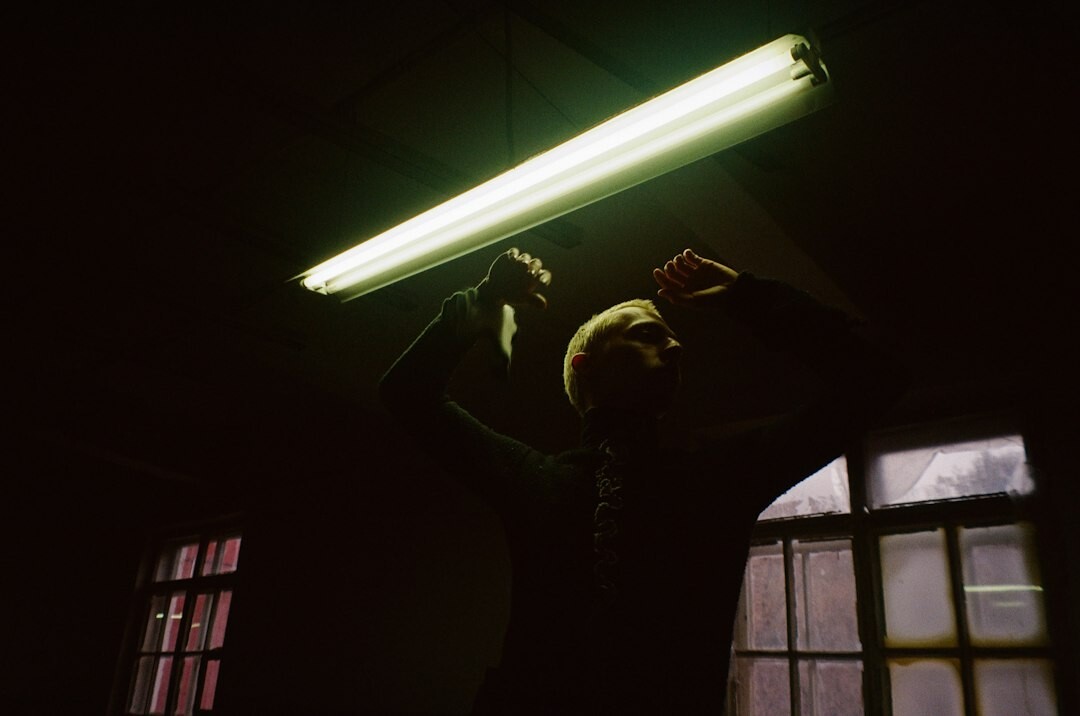 Photographer developing film in a darkroom
