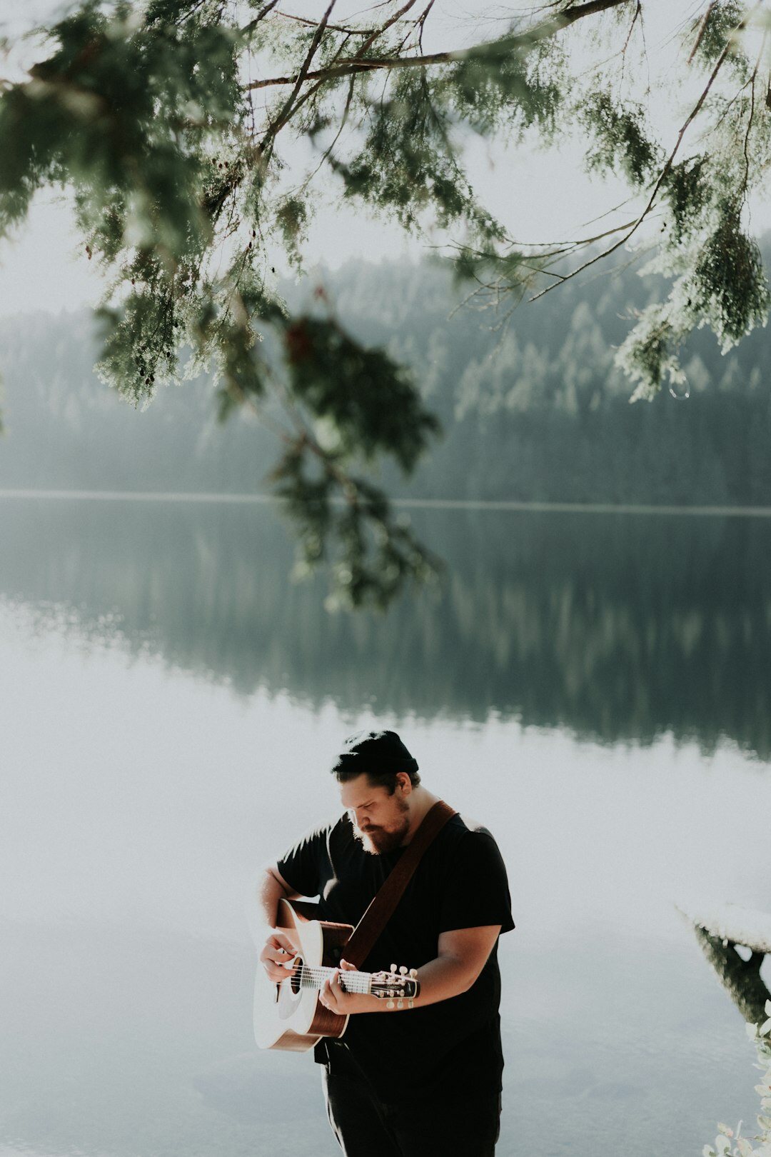Photographer reviewing photos and writing field notes outdoors