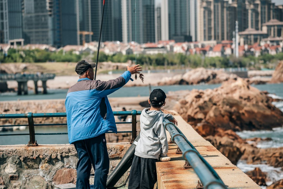 fisherman teaching grandson