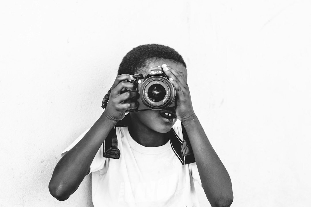 young boy taking photo
